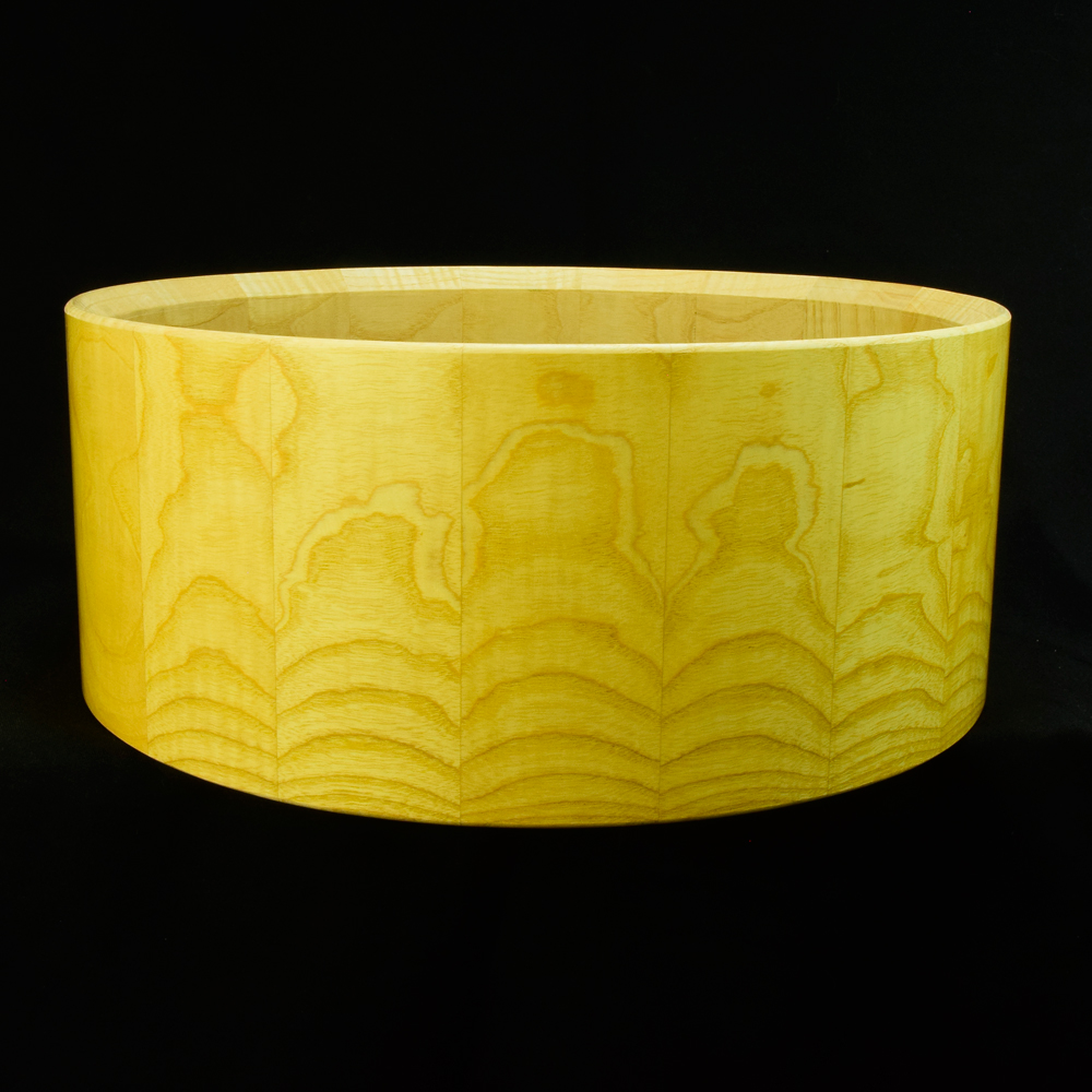 Ash stave snare drum shell in horizontal orientation