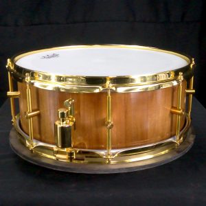 Cherry stave snare drum with brass hardware